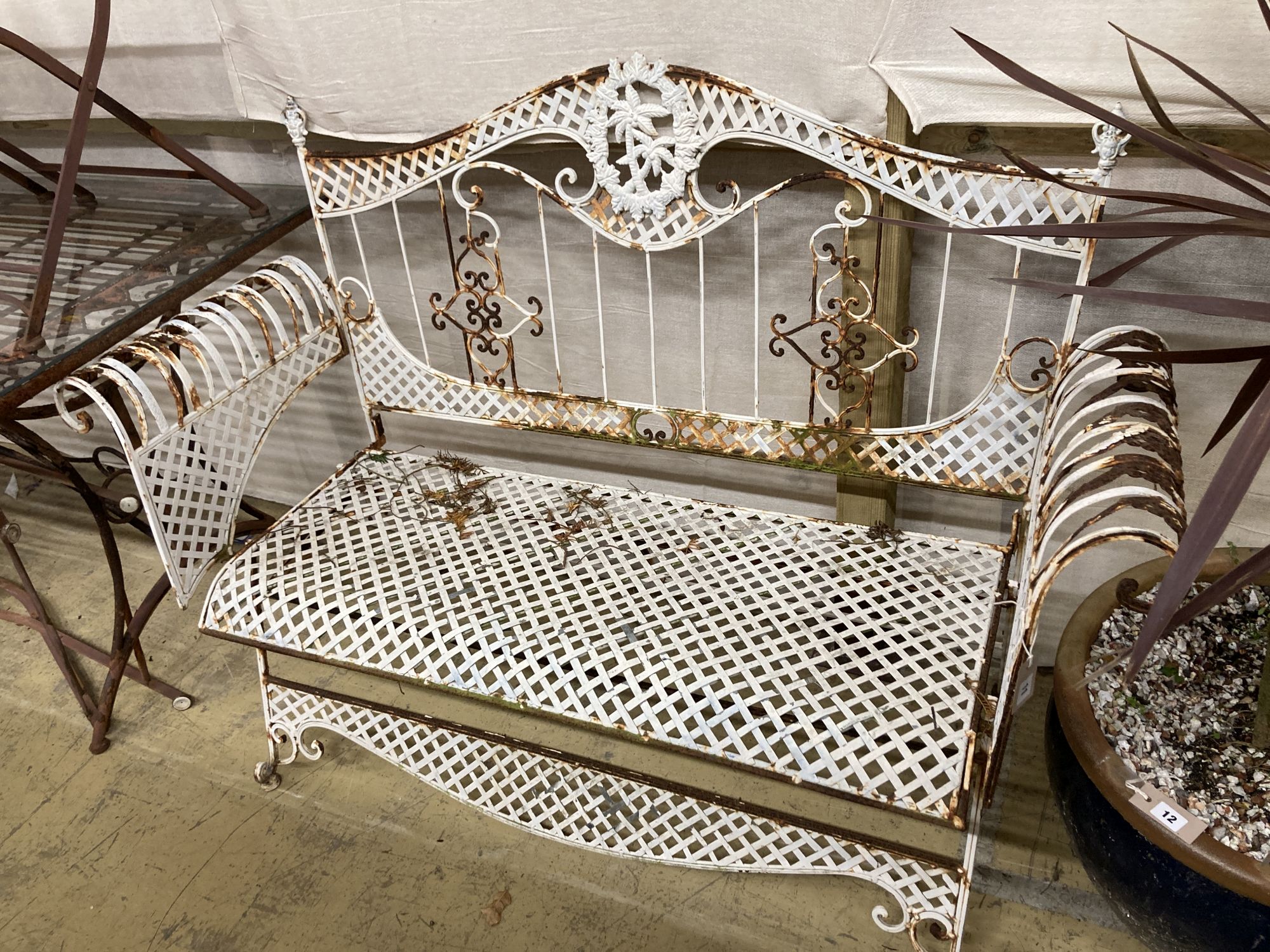 A painted wrought iron garden bench, length 138cm, depth 50cm, height 102cm